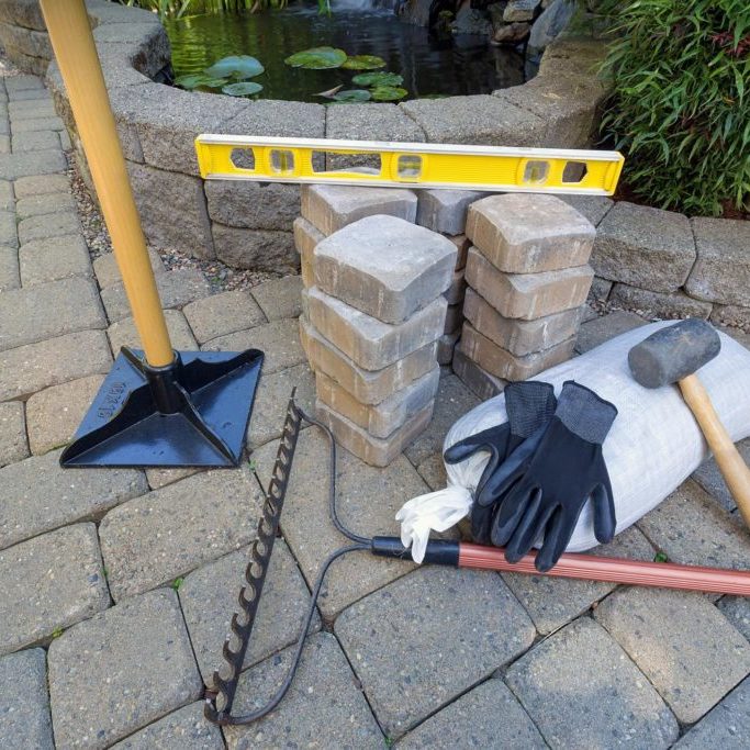 cement tile with hammer and rake
